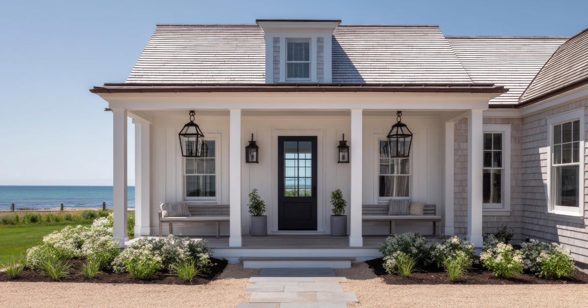 Charming beachfront cottage in Brigantine, NJ with a welcoming front porch, coastal landscaping, and ocean views—ideal for showcasing premium vacation rentals on ShoreSummerRentals.com.