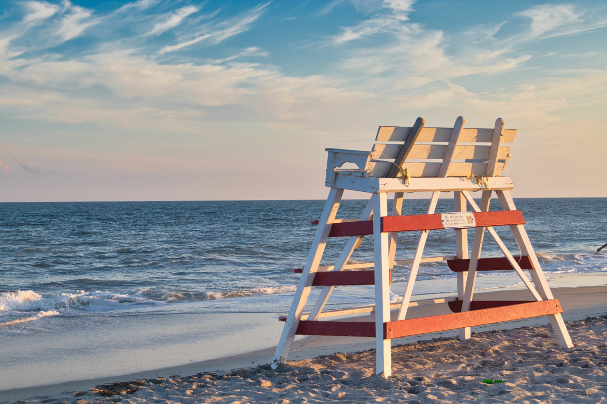 Scenic view of the best beaches in Cape May featuring soft sand, calm ocean waves, and a clear blue sky.